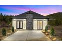 Beautiful home with gray roof, stone accents, and a driveway leading to the front entrance at 499 Silver Creek Rd, Idaho Springs, CO 80452
