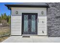 Close-up of the ornate front door with decorative glass and stone accents, adding to its curb appeal at 499 Silver Creek Rd, Idaho Springs, CO 80452