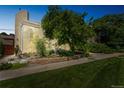 Modern home features a large window and lush landscaping, creating a beautiful curb appeal at 461 Fillmore St, Denver, CO 80206
