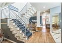 Spacious foyer with modern staircase, hardwood floors, and open layout offer a bright welcoming entrance at 461 Fillmore St, Denver, CO 80206
