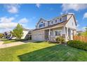 Charming two-story home with a well-manicured lawn and a two-car garage at 16478 Marion St, Thornton, CO 80602