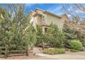 Side view of home featuring manicured shrubbery, trees and steps leading to the entrance at 368 Dallas St, Denver, CO 80230