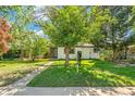 Cozy home with mature tree in the front yard and a real estate sign at 5008 Alcott St, Denver, CO 80221