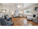 Comfortable living room with lots of natural light, hardwood floors, and neutral color palette at 5008 Alcott St, Denver, CO 80221