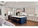 Modern kitchen with stainless steel appliances, a large island with seating, and plenty of counter space at 5861 Tesoro Pt, Parker, CO 80134