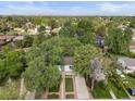 Stunning aerial view of a home surrounded by lush greenery with the cityscape on the horizon at 2967 Olive St, Denver, CO 80207