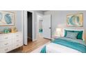 Bright bedroom featuring wood floors, stylish decor, and a comfortable bed at 1705 S Yuma St, Denver, CO 80223