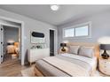 Cozy bedroom with neutral decor, wood flooring, and plenty of natural light at 1705 S Yuma St, Denver, CO 80223