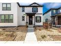 Inviting home featuring white siding, black trim, and a cozy front porch, perfect for relaxing outdoors at 8358 Howell St # B, Arvada, CO 80005