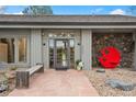 Charming front entrance with modern decor and stone accents on this lovely home at 32399 Woodland Dr, Evergreen, CO 80439
