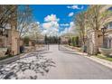 Elegant gated community entrance with stone pillars and manicured landscaping offers security and prestige at 2616 E Cherry Creek South Dr, Denver, CO 80209