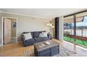 Inviting living room with a cozy gray sofa, view of the city skyline, and access to a balcony at 1301 Speer Blvd # 403, Denver, CO 80204