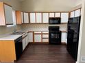 Kitchen equipped with black appliances, white counters and two-tone cabinets at 6610 Monaco Way, Brighton, CO 80602