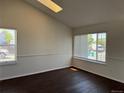 Bright living room featuring hardwood floors, large windows, and neutral paint colors at 6610 Monaco Way, Brighton, CO 80602