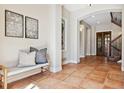 Lovely foyer with stained wood door, charming decor, and beautiful tile floors at 2975 E Wesley Ave, Denver, CO 80210