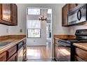 Kitchen featuring wood cabinets, a laminate countertop, and stainless steel appliances at 4634 S Fraser Ct # F, Aurora, CO 80015