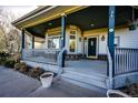 Inviting front porch with ample space and charming details at 935 Green Gables Cir, Bennett, CO 80102