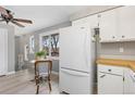 Kitchen featuring white appliances, light grey walls and hardwood style floors at 159 Judson St, Longmont, CO 80501