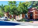 Charming brick building with mature trees, a car parked nearby, adding to the curb appeal at 1767 N Washington St, Denver, CO 80203