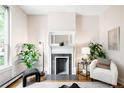 Living room featuring a decorative fireplace, hardwood floors, and ample natural light at 1767 N Washington St, Denver, CO 80203