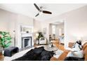Open living room with fireplace, hardwood floors, and a glimpse into the adjacent kitchen at 1767 N Washington St, Denver, CO 80203