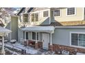 Townhome exterior showcasing winter landscaping and a welcoming entrance at 12961 Lafayette St # B, Thornton, CO 80241