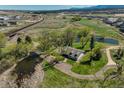 Expansive property featuring multiple ponds, mature trees, and lush greenery for privacy and serenity at 16440 Old Denver Rd, Monument, CO 80132