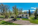 Charming home boasting a well-manicured lawn, dormer windows, large trees, and a welcoming front entrance at 16440 Old Denver Rd, Monument, CO 80132