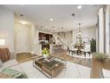 Open-concept living space with modern furnishings, flowing into the kitchen and dining area for seamless entertaining at 3386 Valentia St, Denver, CO 80238