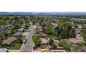 Gorgeous aerial view of a residential neighborhood with mature trees and mountain views at 1229 W 102Nd Ave, Northglenn, CO 80260