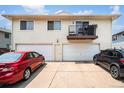 Two-car garage with parking spaces and building view at 7309 W Hampden Ave # 402, Lakewood, CO 80227