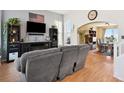 Inviting living room with hardwood floors, a built-in entertainment center, and dining room access at 618 S Carlton St, Castle Rock, CO 80104