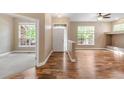 Open-concept living area with hardwood floors, bright windows, and neutral paint colors at 12790 Jackson St, Thornton, CO 80241