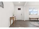Bright foyer with hardwood floors, white walls, and a view of the neighborhood through the window at 3074 Belleville Ridge Rd, Elizabeth, CO 80107
