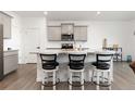 Bright kitchen with breakfast bar seating, stainless steel appliances, granite countertops and modern white cabinets at 3074 Belleville Ridge Rd, Elizabeth, CO 80107