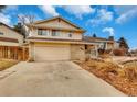 View of the home, including the garage and driveway in front of the house at 983 S Ouray St, Aurora, CO 80017