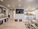 Spacious living room with light wood flooring and a TV mounted on the wall at 10948 Murray Dr, Northglenn, CO 80233