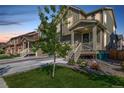 Inviting home exterior with a covered porch, landscaped front yard, and a well-maintained lawn in a desirable neighborhood at 723 176Th Ave, Broomfield, CO 80023
