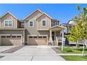 Charming two-story home with a well-manicured lawn and a welcoming front porch on a bright, sunny day at 723 176Th Ave, Broomfield, CO 80023