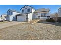 Charming two-story home with a two-car garage, inviting porch, and classic black and white trim at 8588 Sweet Clover Way, Parker, CO 80134