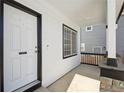 Welcoming front porch with white columns, stylish railing, and a secure front door at 8588 Sweet Clover Way, Parker, CO 80134