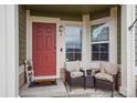 Inviting front porch with seating area next to the front door at 15800 E 121St Ave # 4K, Brighton, CO 80603