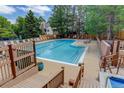 A refreshing community pool with lounge chairs and a wooden deck at 4605 S Yosemite St # 301, Denver, CO 80237