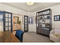 Bright office space with French doors, built in display shelving, and stylish decor creating a perfect work environment at 10828 Valleybrook Cir, Highlands Ranch, CO 80130