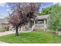 Inviting front entrance with brick accents, flowers, and a cozy porch at 12193 Deerfield Way, Broomfield, CO 80020
