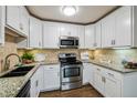 Modern kitchen with stainless steel appliances and granite countertops at 750 S Alton Way # 4B, Denver, CO 80247