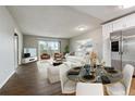 Open-concept living room and dining area with modern decor and great natural light at 750 S Alton Way # 4B, Denver, CO 80247
