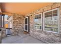 Charming front porch detailed with brick and includes windows for a great view at 20087 E Dartmouth Dr, Aurora, CO 80013