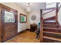 Inviting foyer featuring hardwood floors, staircase, and vintage accents at 2614 E 13Th Ave, Denver, CO 80206