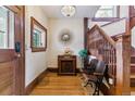 Elegant foyer with hardwood floors, vintage furniture, and a decorative staircase at 2614 E 13Th Ave, Denver, CO 80206